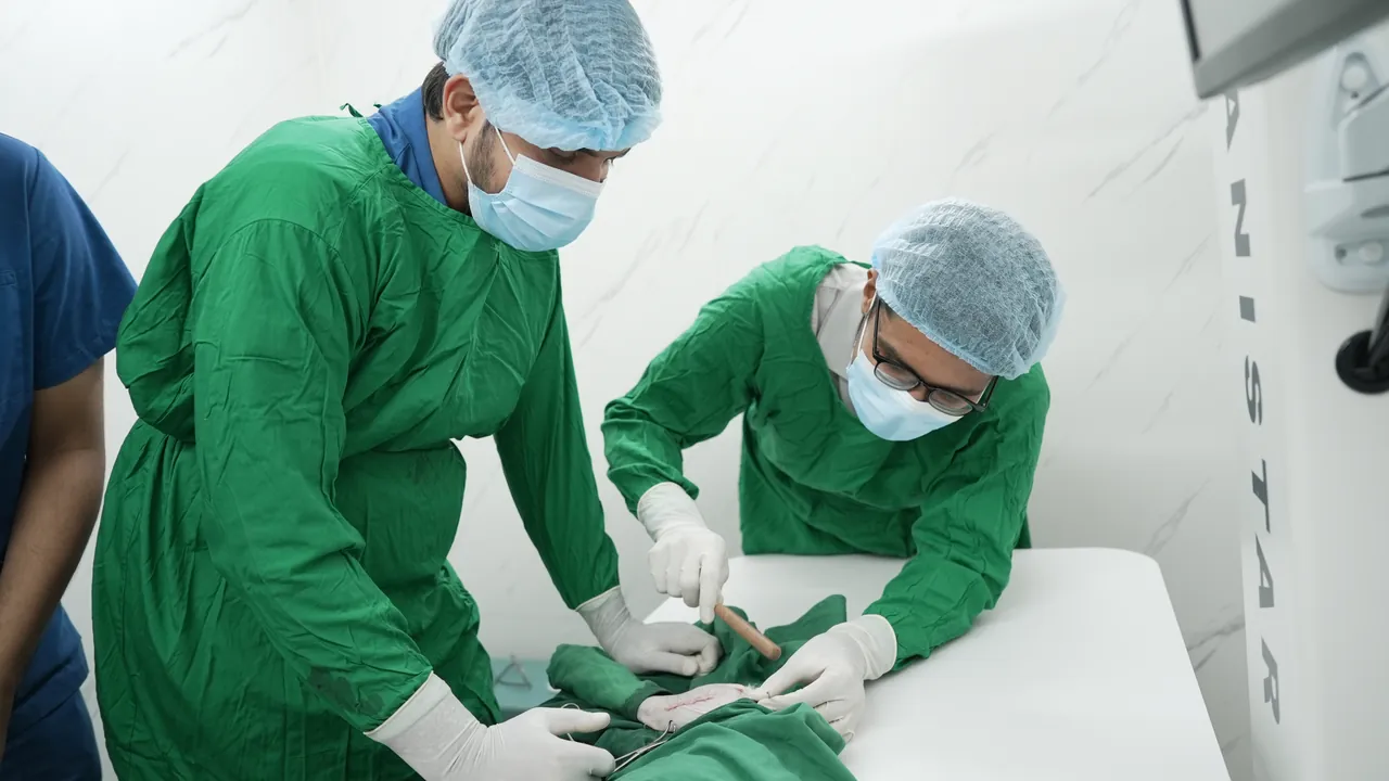 Surgeons in green scrubs during an emergency procedure